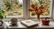 © Anny - Cozy autumn window sill with book, tea, and pumpkin during fall season