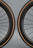 Cycling performance and road bike technology, carbon fiber bicycle wheels with tan wall tires for professional racing and endurance training equipment