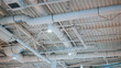 © Sergio - The ceiling features multiple ventilation ducts and lights arranged in a grid pattern. The setting appears to be an indoor commercial space with a focus on functionality