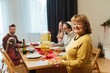 © dsheremeta - Grandmother holding sufganiyot for hanukkah family celebration