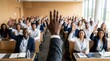 © pakawan - A business seminar with hands raised, representing active participation and audience engagement.