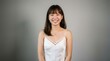 © pakawan - Woman with a joyful expression wearing a white slip dress