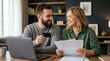 © pakawan - Family web budget and tax calculation with a happy smiling young couple paying bills online via laptop and credit card.