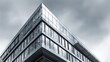© Honey - Modern glass building presents sleek architecture under dramatic stormy clouds, concept for urban development and corporate design