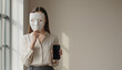 © Olia - Woman Wearing Mask and Using Smartphone Representing Digital Identity