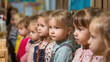© Helena - Group of young girls with various hairstyles and outfits, attentively listening in a classroom setting, showcasing engagement and curiosity in a learning environment