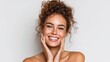 © lulu - Young Woman Smiling Cheerfully with Curly Hair and Clear Skin in Studio Setting