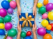 © MdIskandar - Excited hands of people reaching for a beautifully wrapped present with vibrant colorful party balloons all around it