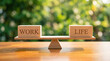 © MdRasel - Wooden balance scale comparing work and life text blocks with mental health