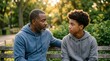 © Panuwat - A father and son having a serious conversation outdoors while bonding and connecting.