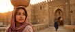 © xuxu - Young woman carrying water jar on head through ancient middle eastern banner format