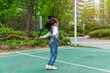 © Li Liu - Happy Asian girl skipping rope outdoors in park, active child exercising and healthy lifestyle concept