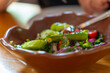 © k_samurkas - Freshly prepared salad with tomatoes, cucumbers, and herbs in a rustic bowl