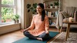 © Azor - Young Indian woman meditating peacefully in lotus pose on yoga mat at home with eyes closed
