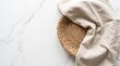© usda - Top view of empty round wicker tray with beige linen napkin on white marble background with copy space