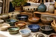 © mila103 - Assorted ceramic bowls arranged on outdoor market table