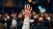 © Stock Spectrum - An audience member raises a hand during a public seminar.