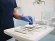 © SimpleDesignStudio - Dentist holding dental tool in clinic, professional oral healthcare and examination procedure