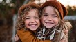 © svastix - This heartwarming image captures two smiling children embracing each other amidst a stunning autumn backdrop, radiating warmth and joy in a cozy atmosphere.