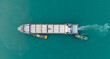 © boygek - A bulk carrier is approaching the berth, with a tugboat pushing it alongside to load cargo.