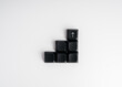 © tete_escape - Black keyboard keys form ascending steps with an upward arrow at the top on white background. Business growth, progress, performance improvement, strategy and technology-driven development concept.
