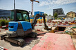 © A-Quantix - Excavator at urban construction site with heavy machinery, earthmoving work, trench excavation, building development and infrastructure construction in a city