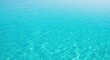 © Alice E - Clear turquoise water with rippling patterns and sunlight reflections. Bright blue-green liquid shows gentle waves creating a peaceful, tranquil scene. Perfect for beach and summer designs.