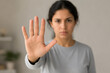 © hr-gold - Woman gestures a stop hand signal expressing refusal and setting a firm boundary