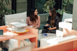 © Zamrznuti tonovi - Businesswomen collaborating on digital tablet in modern office terrace, discussing new project ideas