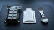 © AbulAI - Military ration chocolate bar and foil packet with spork on slate