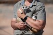 © Moritz Wolf/imageBROKER - Woman holding a meerkat (Suricatta suricata) in her hands, meerkat breeding centre, Northern Cape, South Africa