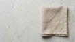 © Ruby - Minimalist top down view of a beige linen napkin with copy space on gray marble.