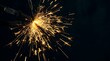 © Freyaundiclosed - Bright burning sparkler held by metal pliers against dark background