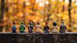 © Rafli - Miniature figures from behind enjoying the vibrant autumn foliage, reflecting on nature's beauty and the serene forest landscape