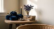 © Rendara Studio - Navy velvet pumpkins beside brass candlestick and stacked books on wooden table