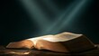 © Fluffik - Light shines on an opened Holy Bible, symbolizing faith and religion in a quiet space