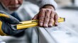 © KORANIS - Close-up of a craftsman using a spirit level to measure accuracy, highlighting precision and skill in their work