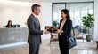 © Evandro - Businessman handing a premium gift box to a smiling client in modern office lobby