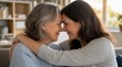 © Prema - Heartwarming close-up of adult daughter and mature mother embracing tenderly, foreheads touching, smiling with love in cozy sunlit living room, multigenerational family bond and affection