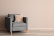 © Pixel-Shot - Comfortable grey armchair in interior of living room