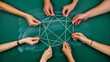 © Fee - Teamwork concept with hands connecting geometric lines on green background