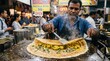 © MdAsaduzzaman - Man prepares masala dosa at busy street food stall in India during evening hours