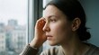 © Png guru - Sad young woman looking through a rainy window feeling lonely depressed and anxious while staying indoors during bad weather and storm outside
