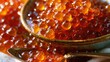 © swillklitch - Extreme macro close-up of glossy red orange salmon caviar fish roe with vivid spherical detail