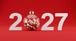 © farhan - Shiny glass bauble filled with tiny colorful spheres representing the number zero sitting between white numbers forming twenty twenty seven on a vibrant solid red studio background for holiday celebra
