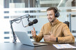 © Liubomir - Podcast host recording audio content.