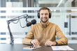 © Liubomir - Podcast host recording audio content.