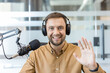 © Liubomir - Podcaster and content creator waving hello.