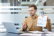 © Liubomir - Remote business meeting and video conference, professional man presenting financial charts and data analysis on a laptop in a modern office. Corporate communication and virtual collaboration.