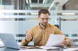 © Liubomir - Work stress and professional burnout, frustrated businessman reading bad news in office report. Stressed employee analyzing financial loss and corporate crisis.